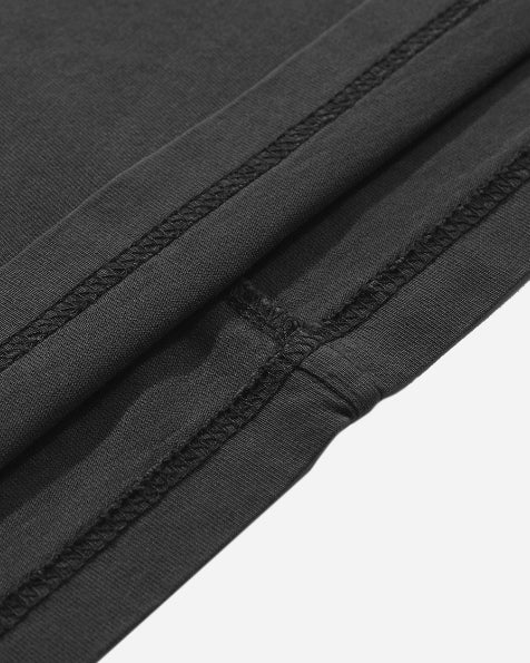 Close-up detail of the bottom hem fabric texture on the garment dyed drop shoulder heavy tee