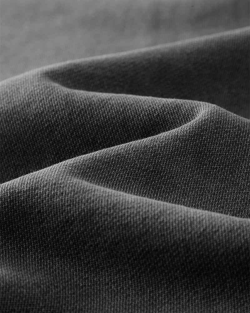 Detailed view of the fabric on the Heavy Hoodie in Washed Black, emphasizing the texture and quality of the 420gsm cotton.