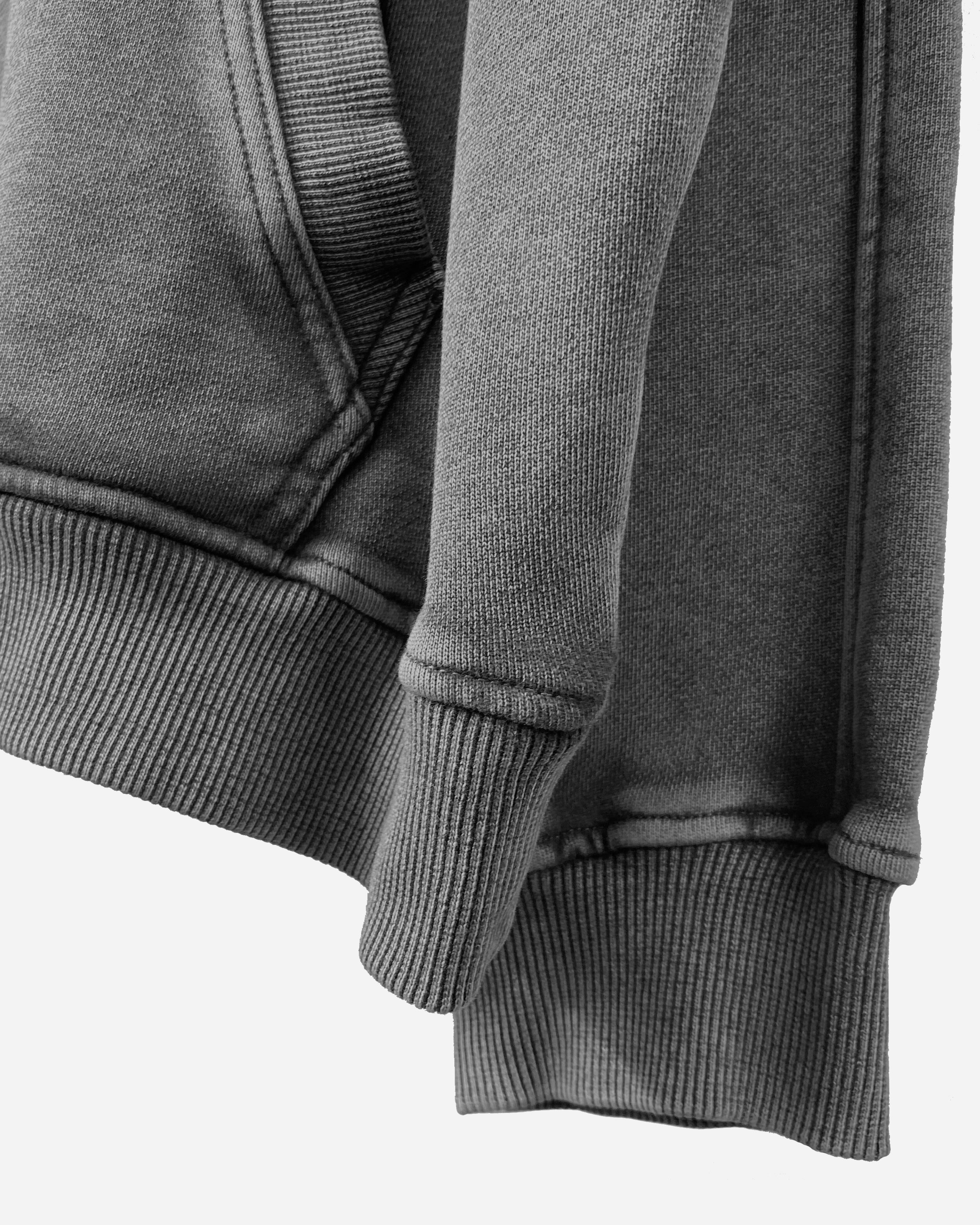 Close-up of the sleeve on the Heavy Hoodie in Washed Black, showcasing the drop shoulder design and 420gsm cotton fabric.