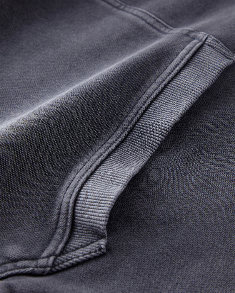 Close-up of the front pocket on the Heavy Hoodie in Washed Blue, displaying the durable stitching and spacious design.