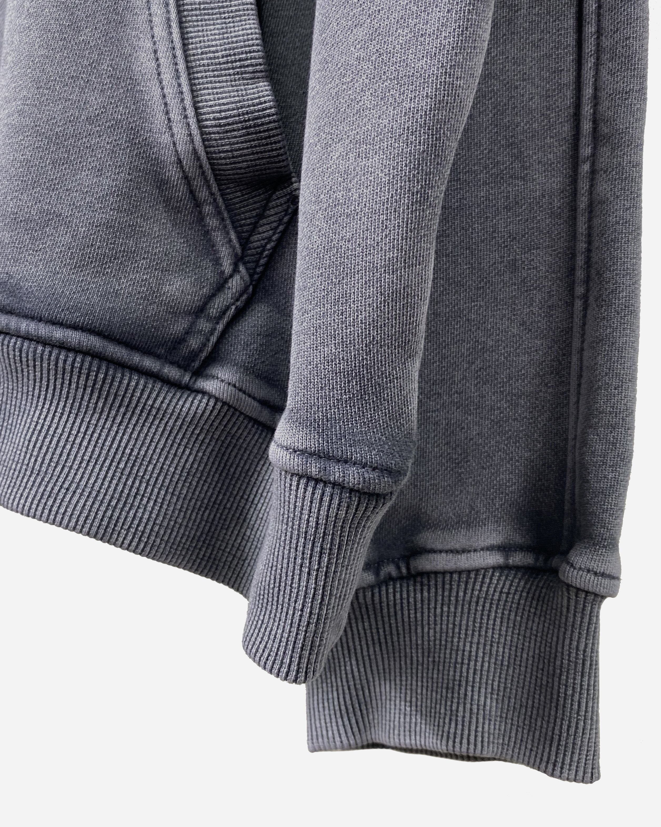 Close-up of the sleeve on the Heavy Hoodie in Washed Blue, showcasing the drop shoulder design and 420gsm cotton fabric